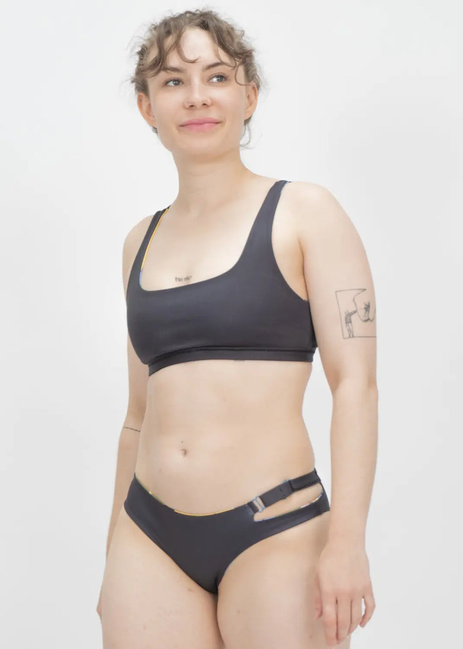 Black two-piece athletic swimsuit with a sports bra top and bikini bottom.